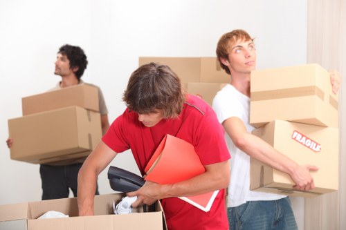 Professional movers unloading boxes at a new flat in Twickenham