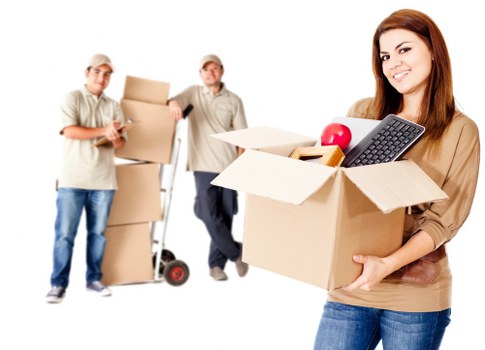 Mover wearing PPE while carrying furniture in Twickenham